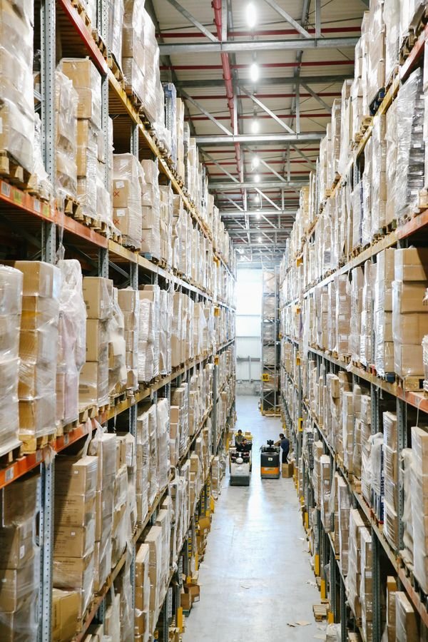 Warehouse aisles with shelves stacked with inventory boxes